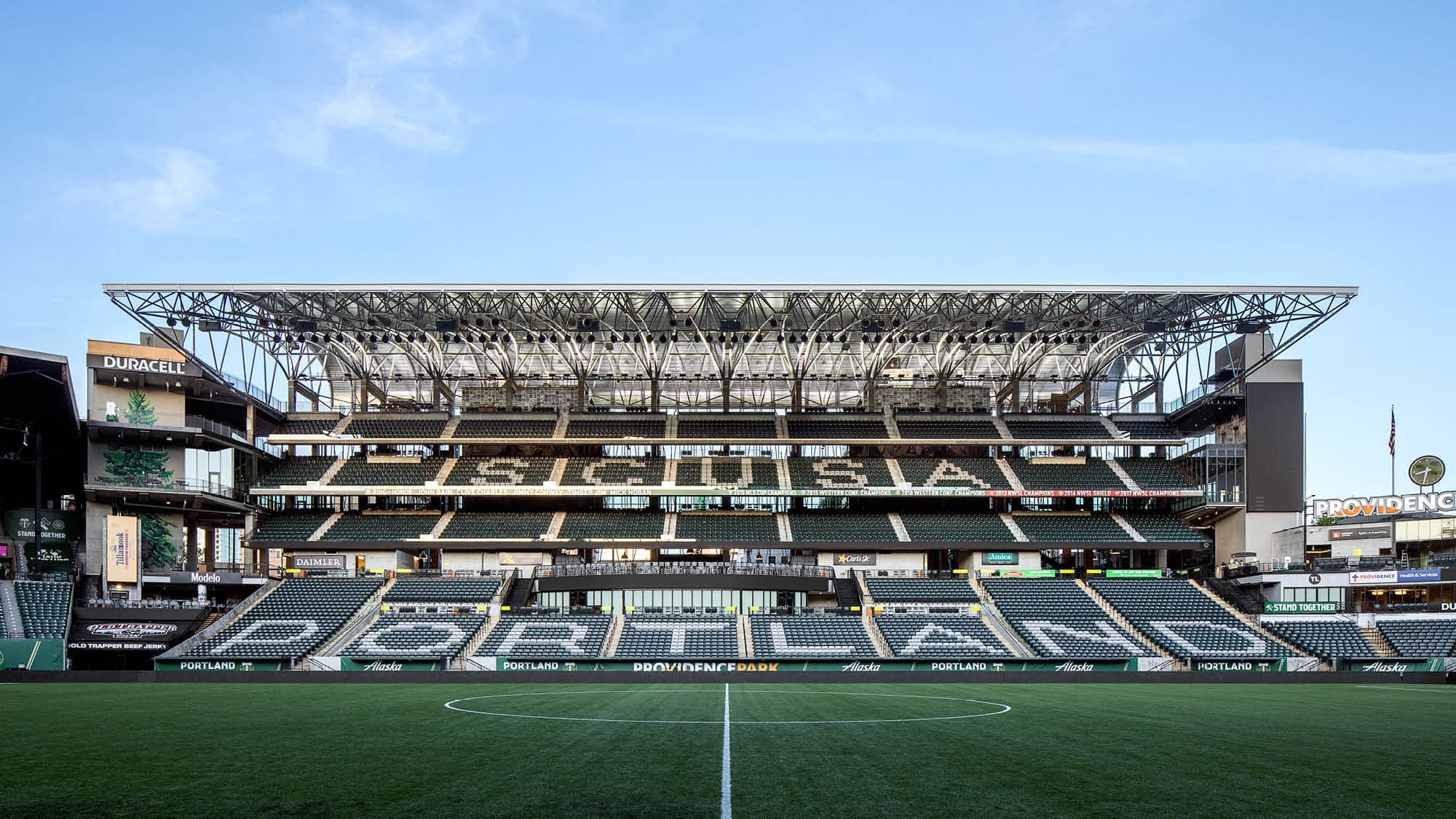 Providence Park stadium interior from the south goal, wood-truss canopy, Timbers branding on the stadium seats, Portland, Oregon