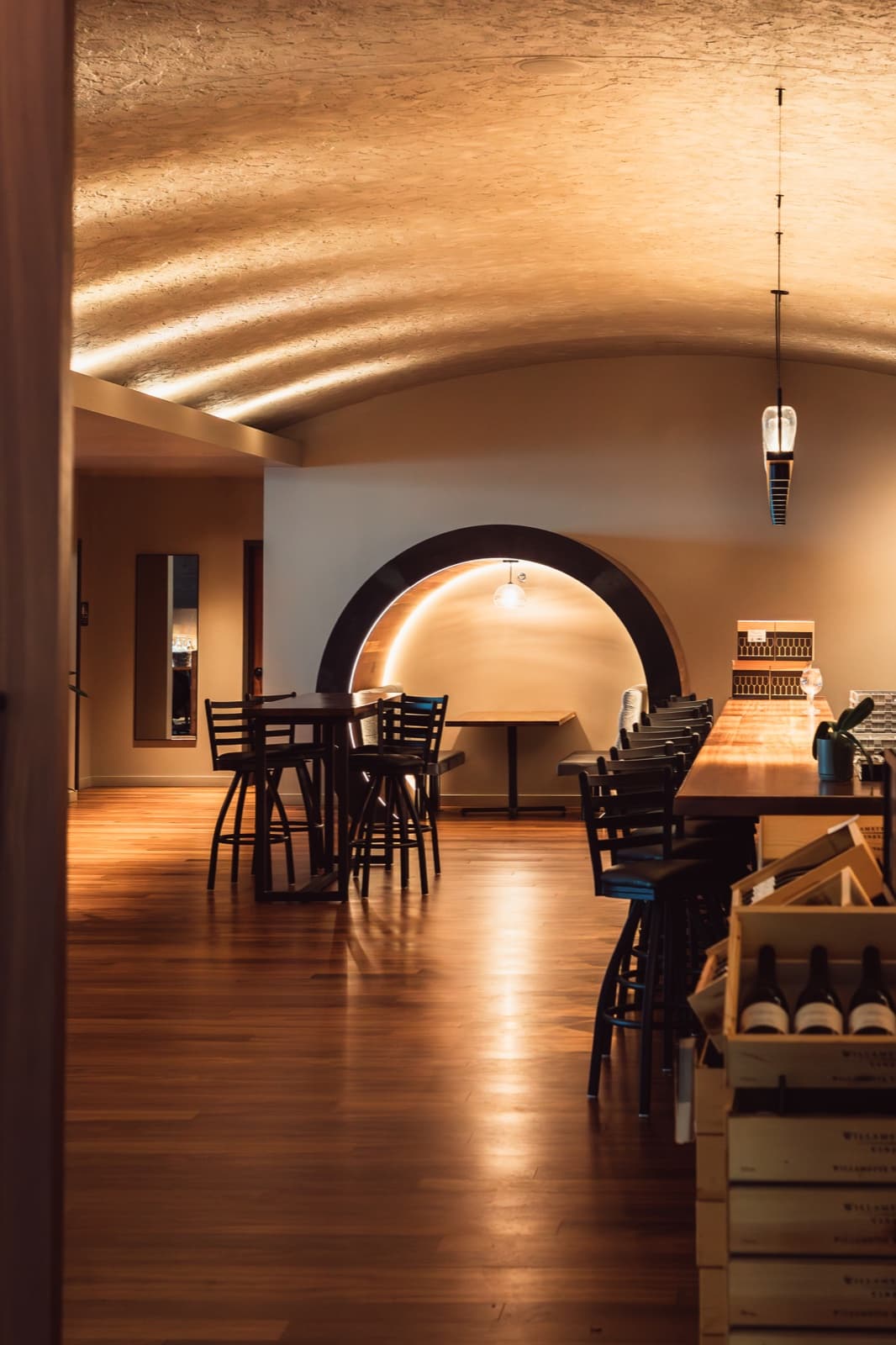 Interior of Willamette Valley Vineyards tasting room on the Vancouver waterfront with barrel-vaulted drywall ceiling